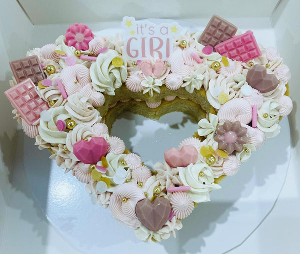It's a girl, pink baby shower layered heart cake